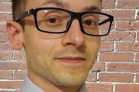 Head shot of Luke Jensen, candidate for Maine House District 96. He is smiling and wearing glasses
